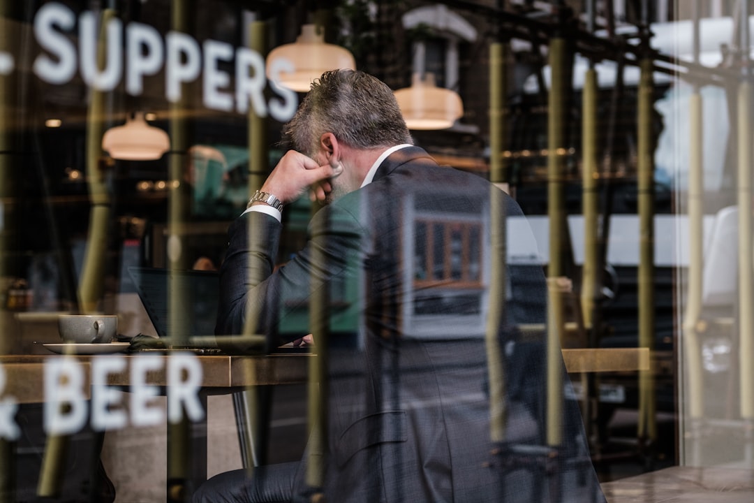 business owner looking at a negative Google review on a laptop