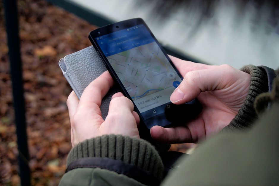 person using a smartphone to find a nearby business on Google Maps